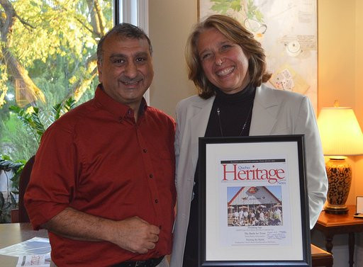 Lachine Mayor Maja Vodanovich (right) received a framed copy of Quebec Heritage News from Ro Ghandhi (September 2019)