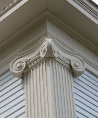 The massive pilasters at the corners of the old Baker Bank and the columns on the building's porch are striking examples of neo-classical design. The pilasters and columns are of the Ionic order.