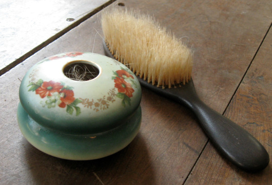 Hair brush and hair receiver, c.1900.
When brushing her hair, a woman would collect the long strands from her brush and place them for safe-keeping in a hair receiver bowl.
(Compton County Museum Collection / Photo - Jackie Hyman)