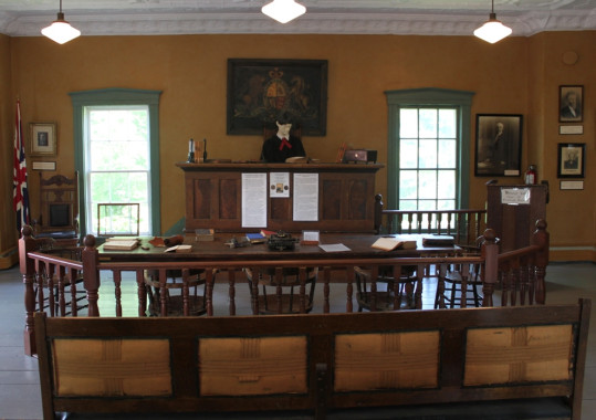 The old court room still contains many of its original nineteenth century trappings. In this view, only the judge is a recent addition! (Photo - Matthew Farfan)