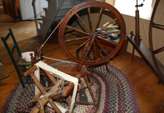 Treadle wheels, 19th century. 
Flax, the plant which produces linen, was spun on a small wheel called a "Saxony wheel" or a "treadle wheel." The spinner sat and turned the wheel by means of a foot treadle. The small wheels required far more craftsmanship in their construction than the larger wheels which were used exclusively for wool. Treadle wheels were among the prized possessions of early settlers. 
(Missisquoi Historical Society Collections)