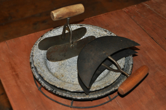 Pastry cutters and pie plates, c.1890.
Two days in the week were usually set aside for baking. Most women produced their own bread, cakes and pies. Baking days allowed time to put the kitchen and pantry in order. Pantry shelves were cleaned and freshly papered, produce was checked for decay, tins and jars were cleaned and supplies were monitored. In the kitchen, the black iron stove was cleaned and burnished and the kitchen and pantry floors were swept and washed.
(Missisquoi Historical Society Collection