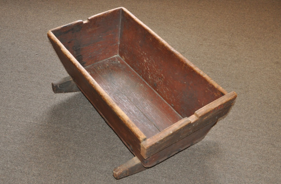 Handmade wooden cradle, c.1820s. 
Among her daily chores a woman's most important role was that of mother. Caring for her children was perhaps so commonplace and expected that diarist Hannah Selby of Dunham did not even list it as a task in her weekly duties. Child rearing in the 19th century could be a busy and happy time in a woman's life but it was also fraught with hardship and heartache. High maternal mortality rates in child birth and high infant mortality rates meant that women readily understoo
