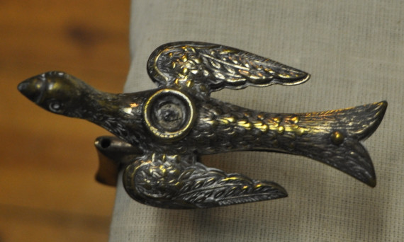 Sewing Bird c.1840.
The sewing bird, or hemming bird, was clamped to the table while the material was placed in the spring closure of the bird's beak leaving the sewer's two hands free to sew and hold the fabric. 
(Missisquoi Historical Society Collections)