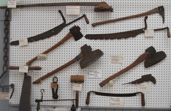 Broad axes for squaring building logs; other carpenter's tools. (Compton County Museum Collection / Photo - Charles Bury)