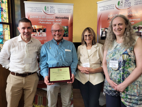 Ed Pedersen (second from left) receiving his award.