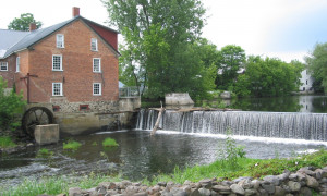 The Cornell Mill, seen here from the opposite bank of the Pike River, was built in 1830. It has been home to the Missisquoi Historical Society since 1964.
