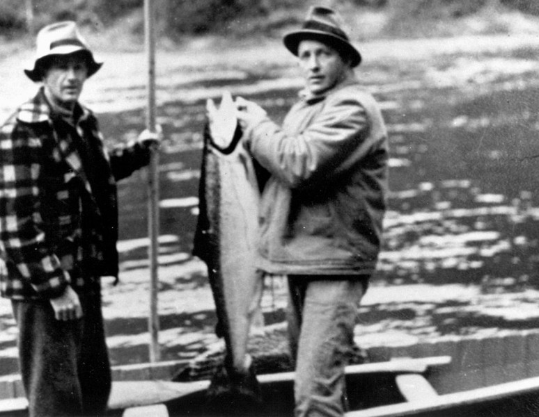 The Cascapedia has attracted the rich and famous since the mid-nineteenth century when the river was the haunt of royalty. In this grainy snapshot, Hollywood actor and crooner Bing Crosby (right) holds up his catch. Crosby's guide, Charlie McCormack, is to the left. (Photo - Cascapedia River Museum Collection)