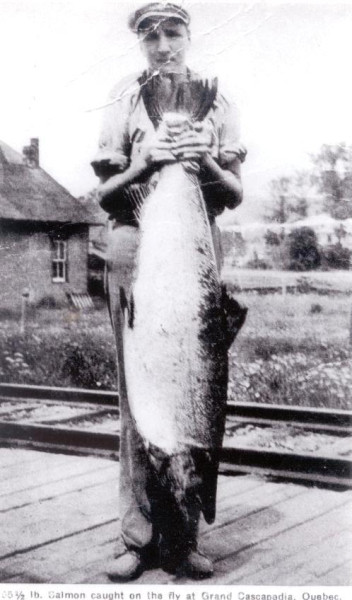 Buddy Campbell holding Esmund Martin's famous 55 1/2 pound salmon, 1939. (Photo - Cascapedia River Museum Collection)


