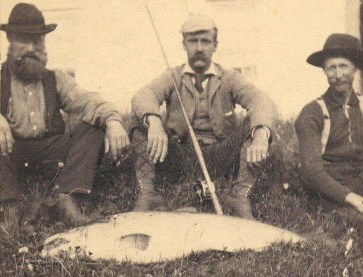 Edmund Davis (centre) with one of his prize fish, c.1890s. Davis is the only fisherman to have ever caught three Atlantic salmon weighing over fifty pounds each on the Cascapedia River. (Photo - Cascapedia River Museum Collection) 