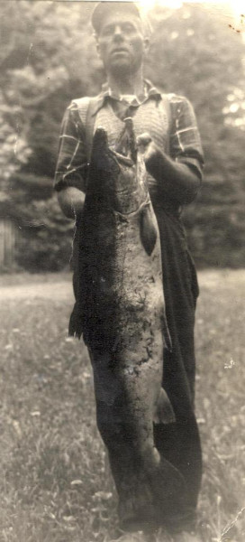 River guide Elzear Coull and his catch. This fish is said by some to have weighed over 60 pounds. If so, that would make it the largest salmon ever taken from the Cascapedia River. Unfortunately, there is no documentation to prove the fish's actual weight. (Photo - Cascapedia River Museum Collection)