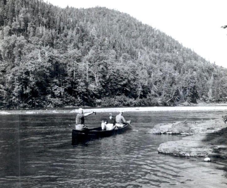 Elzear Coull guiding anglers up the Cascapedia, c.1940s. (Photo - Cascapedia River Museum Collection)