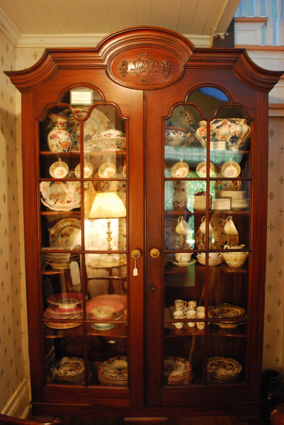 China Cabinet.
Percy Nobbs designed this mahogany china cabinet in 1909 as a wedding gift for his wife Mary Cecilia (Cecil) Shepherd. A very personal piece of furniture, the armoire is embellished with carved flowers and a monogram of Percy and Cecil's intertwined initials, PEN and MC. The armoire remains in excellent condition and has a companion piece in the upstairs bedroom. (Greenwood Collection)
