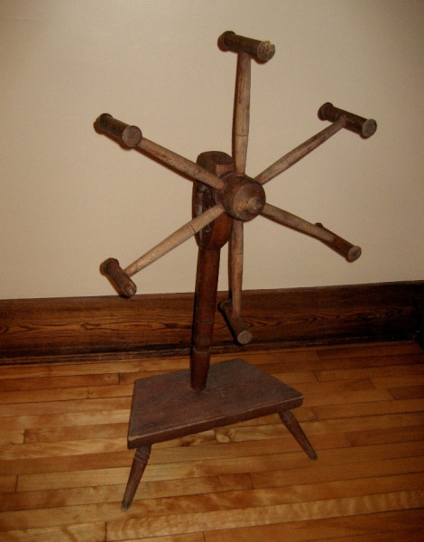 19th Century Skein Winder. Local history buffs have been very generous in sharing their artifacts with Fairbairn House. This six-wheeled skein winder for wool yarn came from a local family collection to help us show some of the tools our pioneers used to make their lives a bit easier. After spinning the sheep's wool and making a two-ply yarn suitable for knitting or weaving, it needed to be wound into skeins for either washing or dyeing. This was done with a winder by attaching an end of the fibre to one 