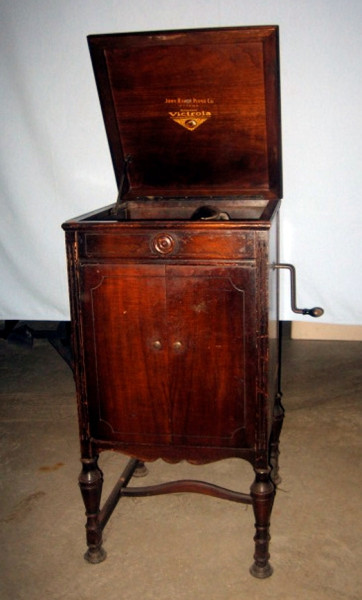 Phonograph Player. This wind-up Victrola was sold in 1925 by the Victor Talking Machine Company of Canada. It displays the well known "His Master's Voice" logo inside the top cover. The local distributor for this popular model was the John Raper Piano Co. of  Ottawa. In this era the wind-up cabinet-model Victrolas were priced from $110 to $250. This prized artifact was received from an out-of-province supporter of Fairbairn House, and a descendant of prominent early settlers in the Gatineau hills. 
(