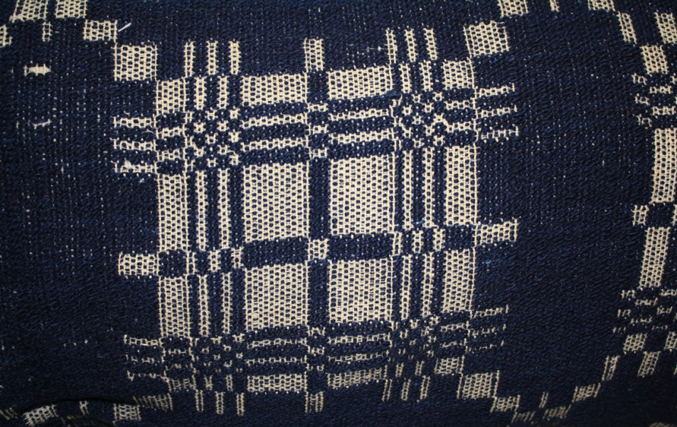 Hand-woven "overshot" coverlet of indigo blue woollen weft on linen warp, mid-18th century. 
(Missisquoi Historical Society Collections)