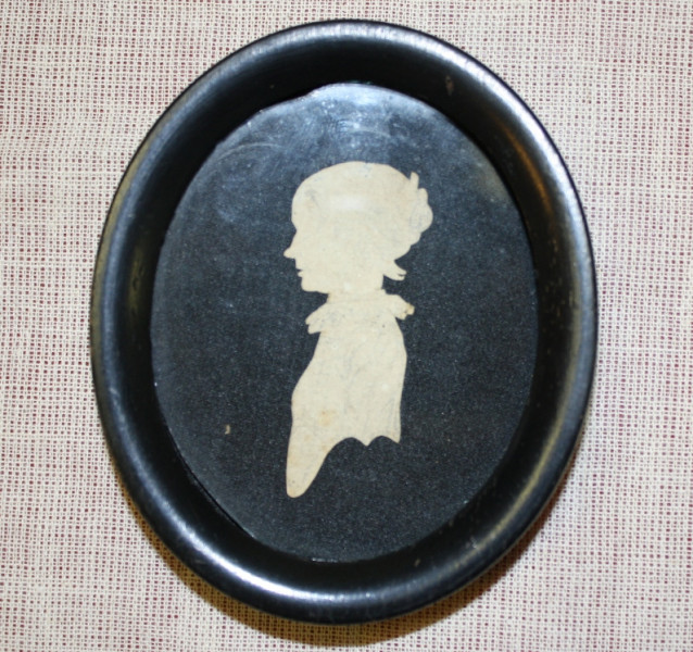 Silhouette, c.1780. 
Prior to photography in the mid 19th century, people either sat for a portrait miniature or had a silhouette cut of their profile. Silhouettes were usually inexpensive, small in size and intended as keepsakes of family members or loved-ones. Silhouettes were often carried in a pocket similar to the way we keep photographs in a wallet.

This silhouette is unusual as most were cut from black paper and pasted onto a white or lighter background paper. This small treasure made its way to 
