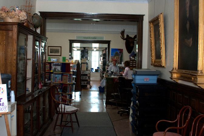 The library interior, from the front door. The circulation desk is in Canada! (Photo - Haskell Free Library)