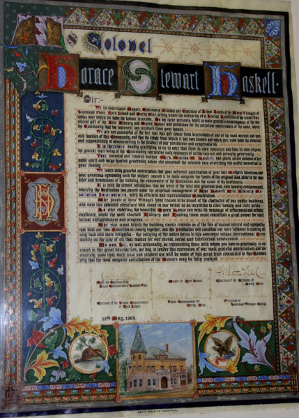 An 'illuminated manuscript' honouring Colonel Haskell is displayed on the wall of the library. (Photo - Matthew Farfan)